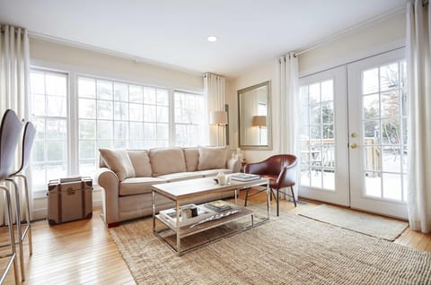Bright, airy living room with double doors that open onto front deck.