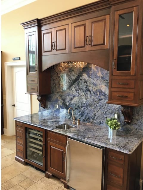 Separate bar area on upper level with incredible blue granite and sink.