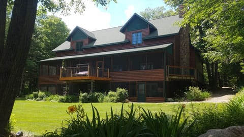 Cabin view from lake.  Sundeck with swinging chair.  2 large 60' screen porches.