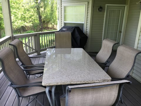 Deck with seating for 8 at the table. Equipped with a gas Weber grill