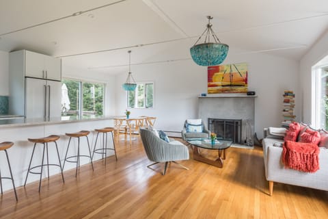 Kitchen/living room with fireplace; screen doors onto patio