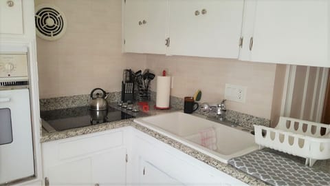 Fully stocked kitchen with cookware and small appliances.