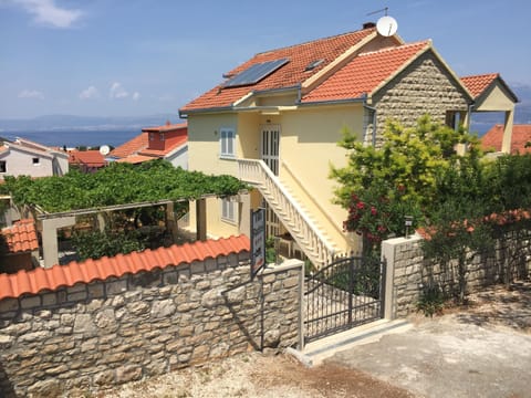 North-East view with entry door and parking place
