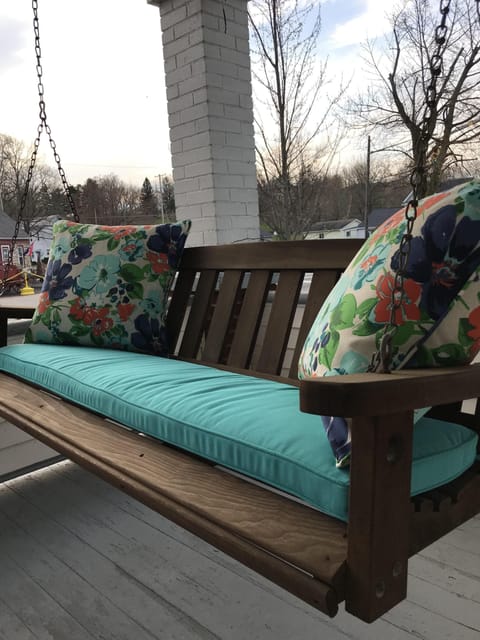 Enjoy a cup of coffee on the front porch swing