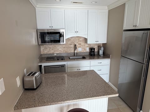 Combination Mircowave/convention oven, flat cooktop, dishwasher & refrigerator.