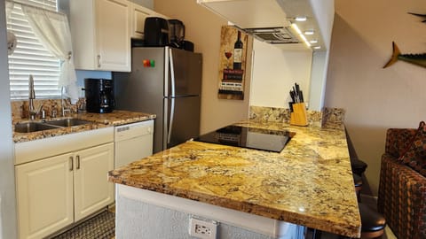 New renovated granite kitchen island with electric cook range. 