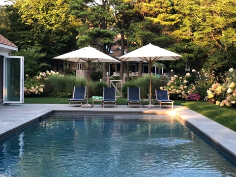 40' foot unite pool. sunbrella kingsley-bate furniture. surrounded by flowers