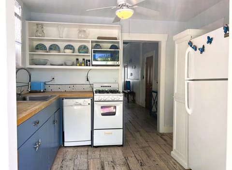 Kitchen with gas range, dishwasher, refrigerator and small appliances.