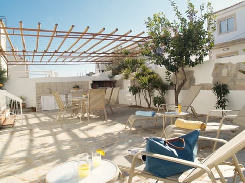 Big back yard with BBQ, patio furniture and sunbeds