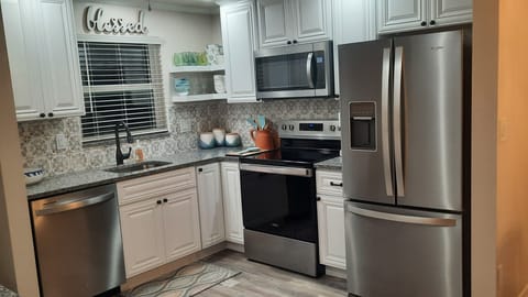 Kitchen with Refrigerator, full stove/oven, dishwasher, and microwave