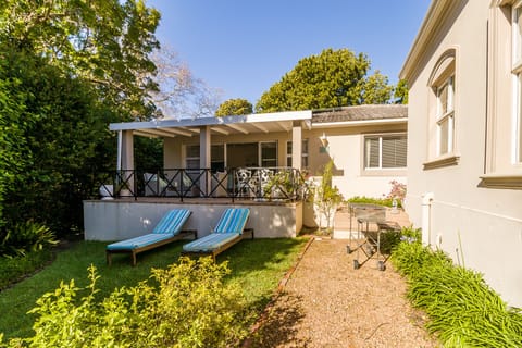 Sunny north facing secluded garden with sun loungers and braai