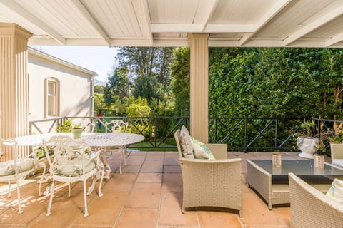 Patio with dining area sitting area leading onto private garden