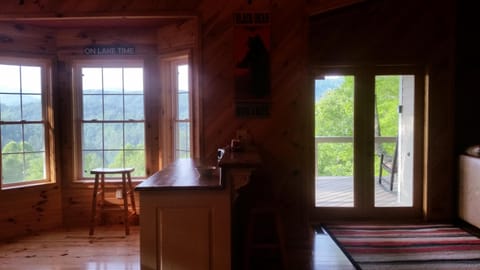 Kitchen bay windows on left, bar, and french double entry doors on right.