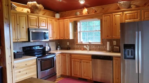 Another view of kitchen, includes smaller appliances, spice rack, soaps & paper.
