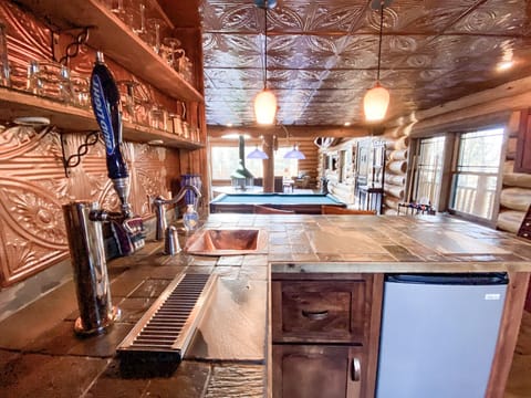 Additional high top seating for 3 can be enjoyed at the wet bar with a birds eye view of the pool table