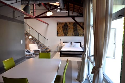 Bedroom with high ceilings, large table for working or eating