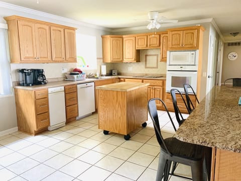 Kitchen has plenty of counter space and is well stocked for your cooking needs. 