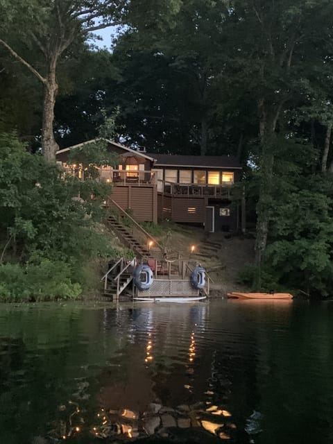 Large deck off the back of the house and steps down to a private waterside dock
