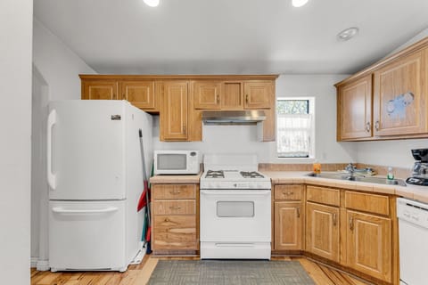 The kitchen is equipped with a stove, microwave, coffee machine, and dishwasher