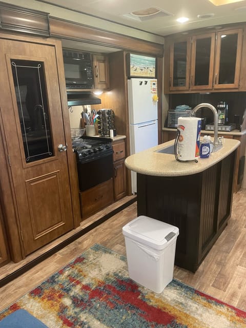 That is a huge pantry on the left of the stove, tons of storage. 10 cu ft fridge