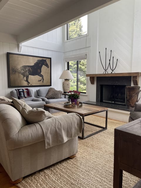 Living room with two-story windows allowing tons of fresh light!