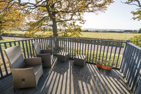 balcony with seating overlooking the fields and hills