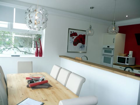 Bright dining area in the kitchen with views over the park 
