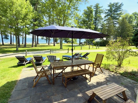 Patio with view to lake. Dining for eight. Solo stove and lounge chairs.