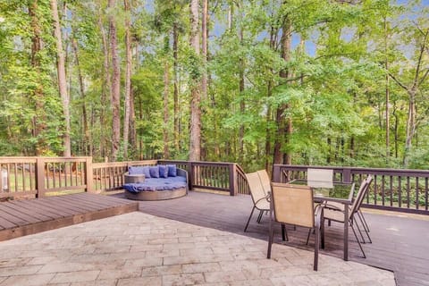 Savor the flavors of summer with this outdoor dining setup, complete with a grill and cozy seating for a night of fun and delicious food