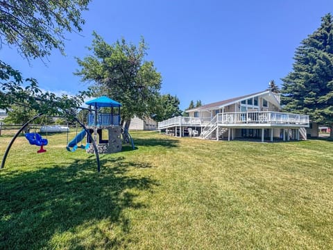 Spacious yard, playground, and expansive deck create the perfect setting for family memories.