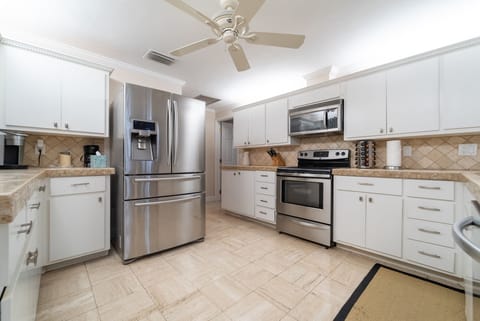 Kitchen with view towards game room, dining room, and pantry, den behind us