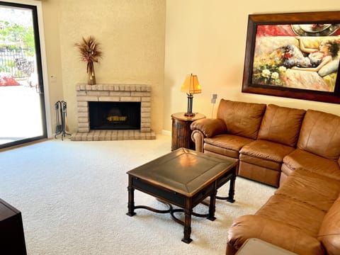Living room includes wood-burning fireplace and backyard patio access. 
