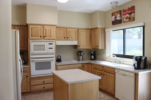 Fully furnished kitchen with extensive quality cookware.  Backyard Patio access.