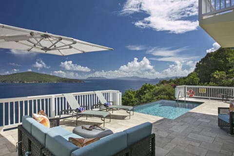 An infinity-edge pool with incredible views and comfy outdoor furniture.