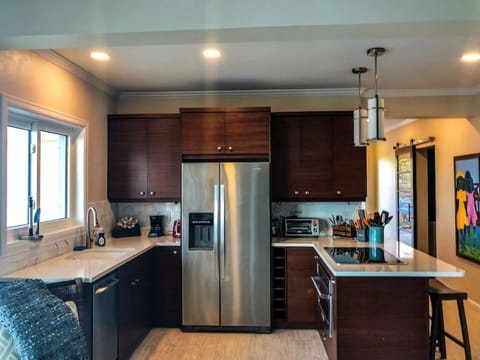 The lower suite`s full kitchen with AC.