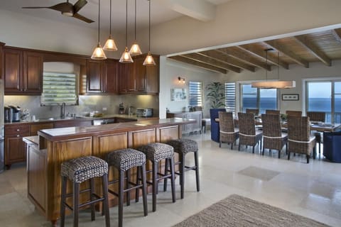 The kitchen and bar area with AC, with the dining room in the background.