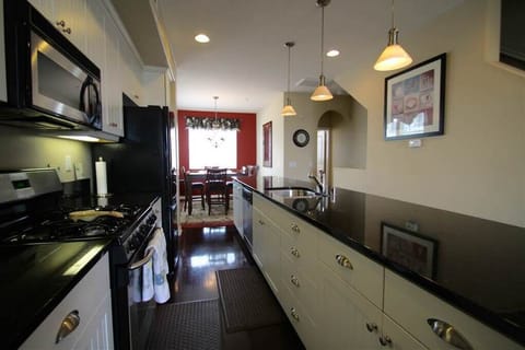 Clean kitchen stocked with dishware, cookware, & appliances you need