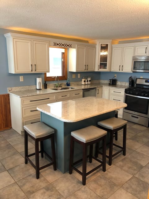 Kitchen w/ dining table and lake view 