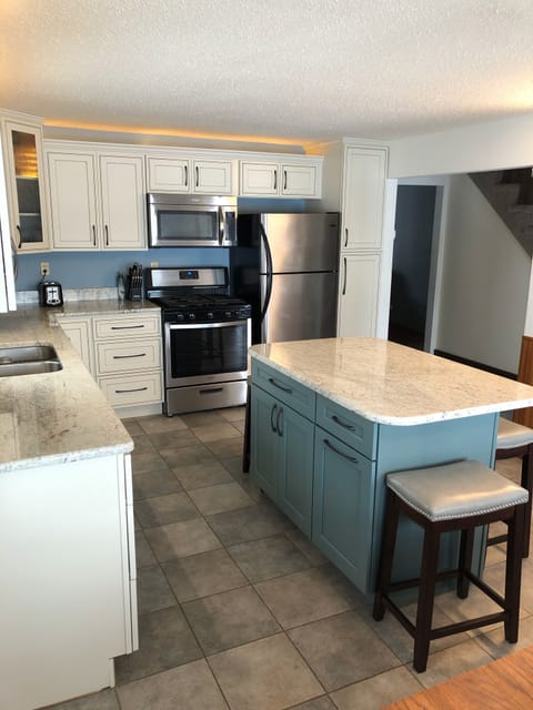 Kitchen w/ dining table and lake view 