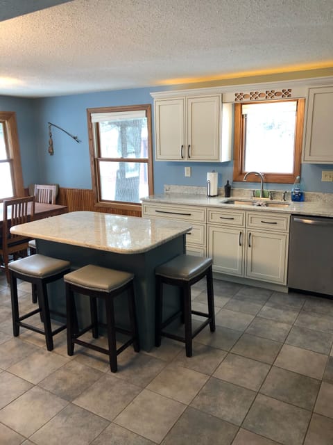 Kitchen w/ dining table and lake view 