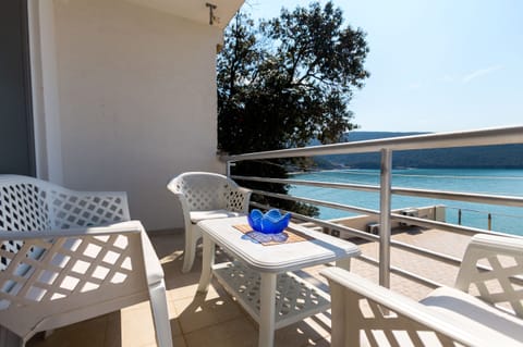 Balcony is Equipped With Outdoor Furniture and Offers Sea View