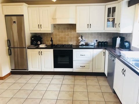 Fully equipped kitchen with adjoining utility room