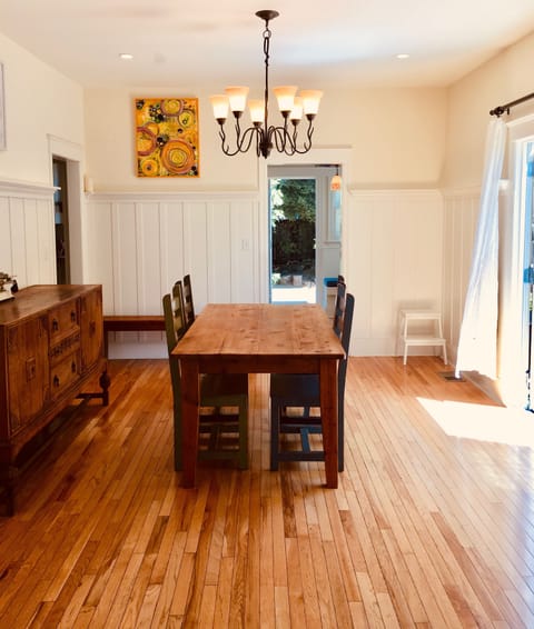Sunlit Dining Room in the center of everything. French doors onto expansive deck