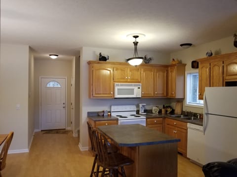 The kitchen is equipped with pots, pans, coffee maker, dishes, silverware, etc.