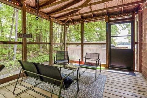 The Upper Scott Lake Retreat screened porch with lounge area is the perfect place to catch up with your friends.