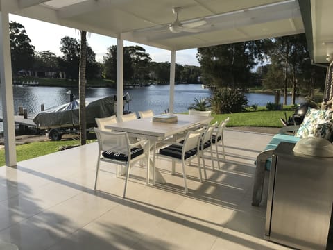 Spacious alfresco dining and direct access to the sandy beach and main channel 