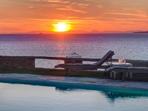 Lying by the pool with a glass of wine enjoying the view
