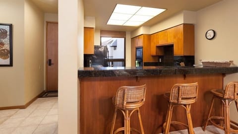 Full kitchen with breakfast bar, granite counters and modern appliances