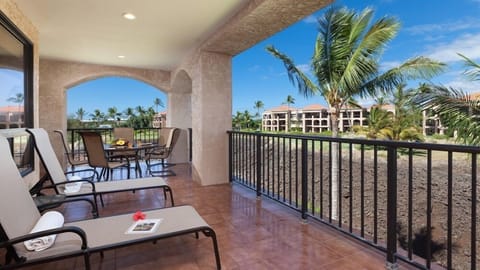 Spacious, covered lanai with glass table and loungers