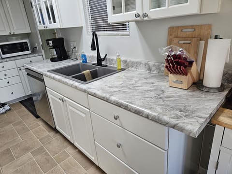 The other side of the kitchen counter with granite sink.